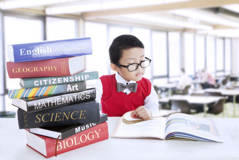 boy-with-a-stack-of-books-studying.jpg