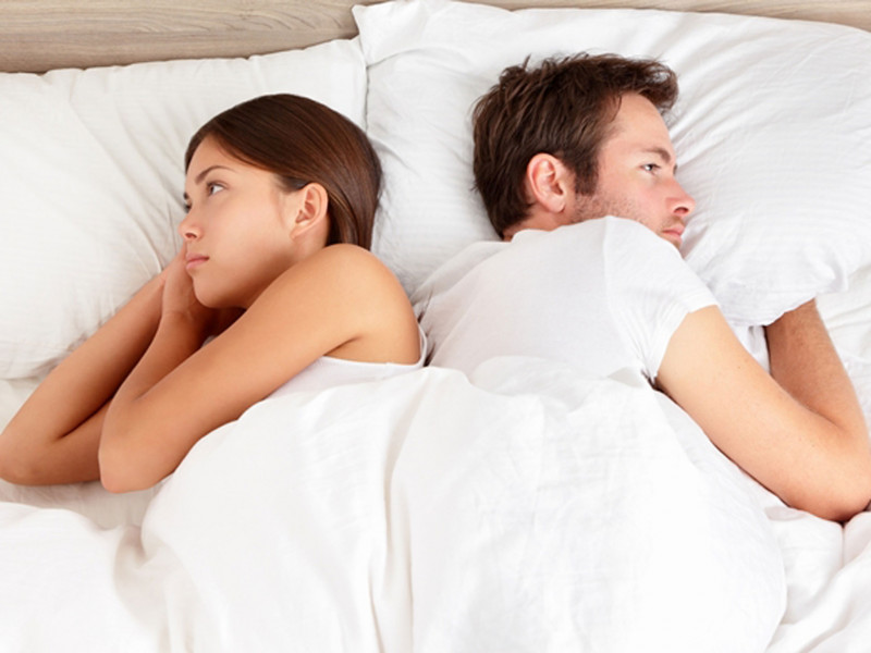 unhappy-couple-sleeping-in-bed-turning-around-their-face.jpg