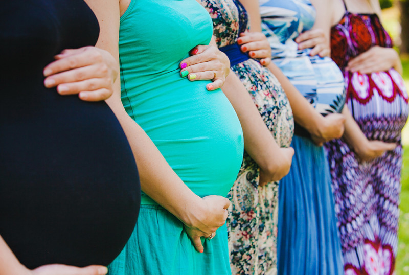 group_of_pregnant_women_holding_bellies.jpg