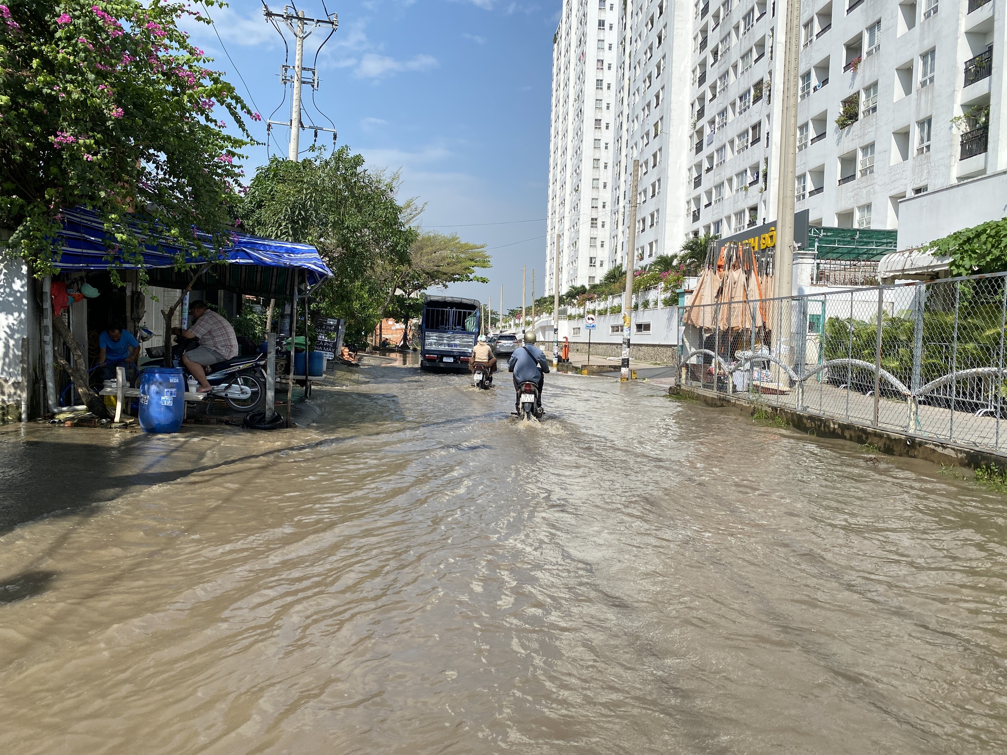 Cư dân ở TP.HCM vật vã lội nước ngập hơn 12 tiếng chưa rút, phương tiện chết máy la liệt  - Ảnh 1.