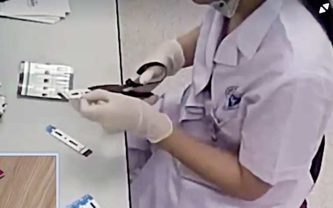 Nhân viên y tế BV Xanh Pôn cắt đôi que thử test HIV và viêm gan B