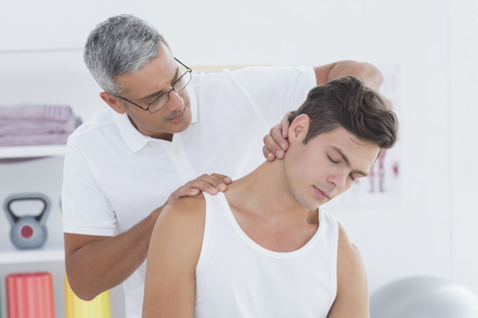 neck-pain-doctor-stretching-therapist-Wavebreakmedia-iStock_000068946871_Medium