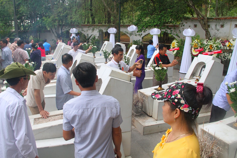 Phần mộ 10 cô gái được đặt ở phía sau tấm bia lớn, tất cả đều sơn màu trắng, di ảnh màu trắng đen.