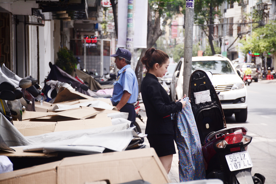 Bảo vệ một ngân hàng trên đường Võ Văn Tần, Q.3, TP.HCM dùng những miếng giấy carton để che xe cho khách dưới cái nắng gay gắt.
