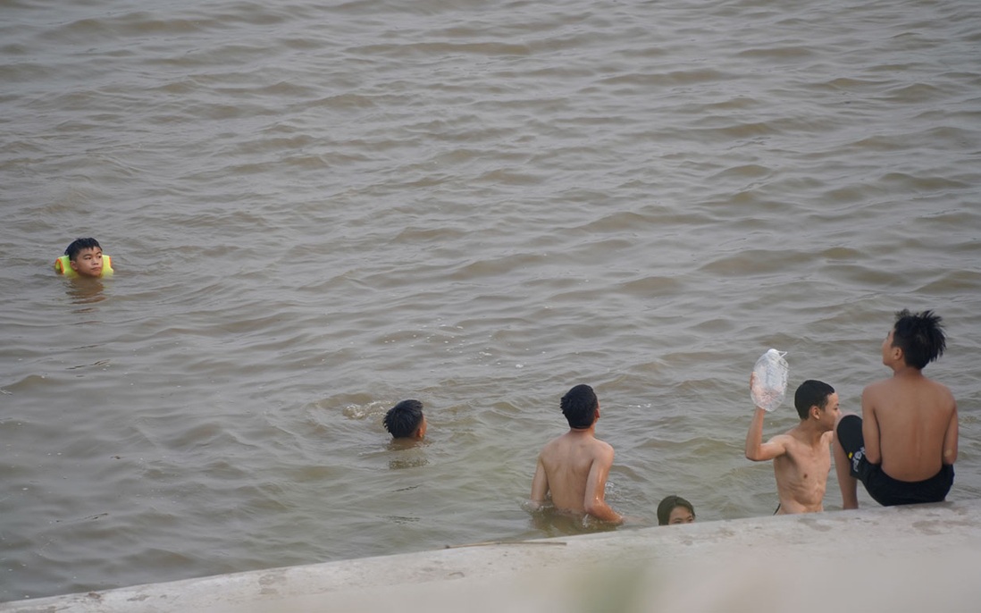 Bất chấp nguy cơ đuối nước, hàng chục người tụ tập bơi lội trên sông Đuống