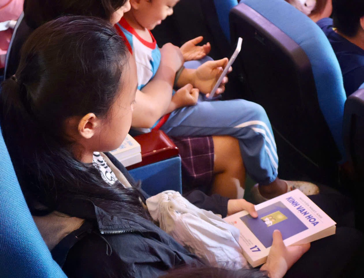 Nhiều bạn nhỏ tham dự sự kiện và cầm trên tay những phiên bản cũ của bộ truyện Kính Vạn Hoa. Ảnh: Hồ Lam