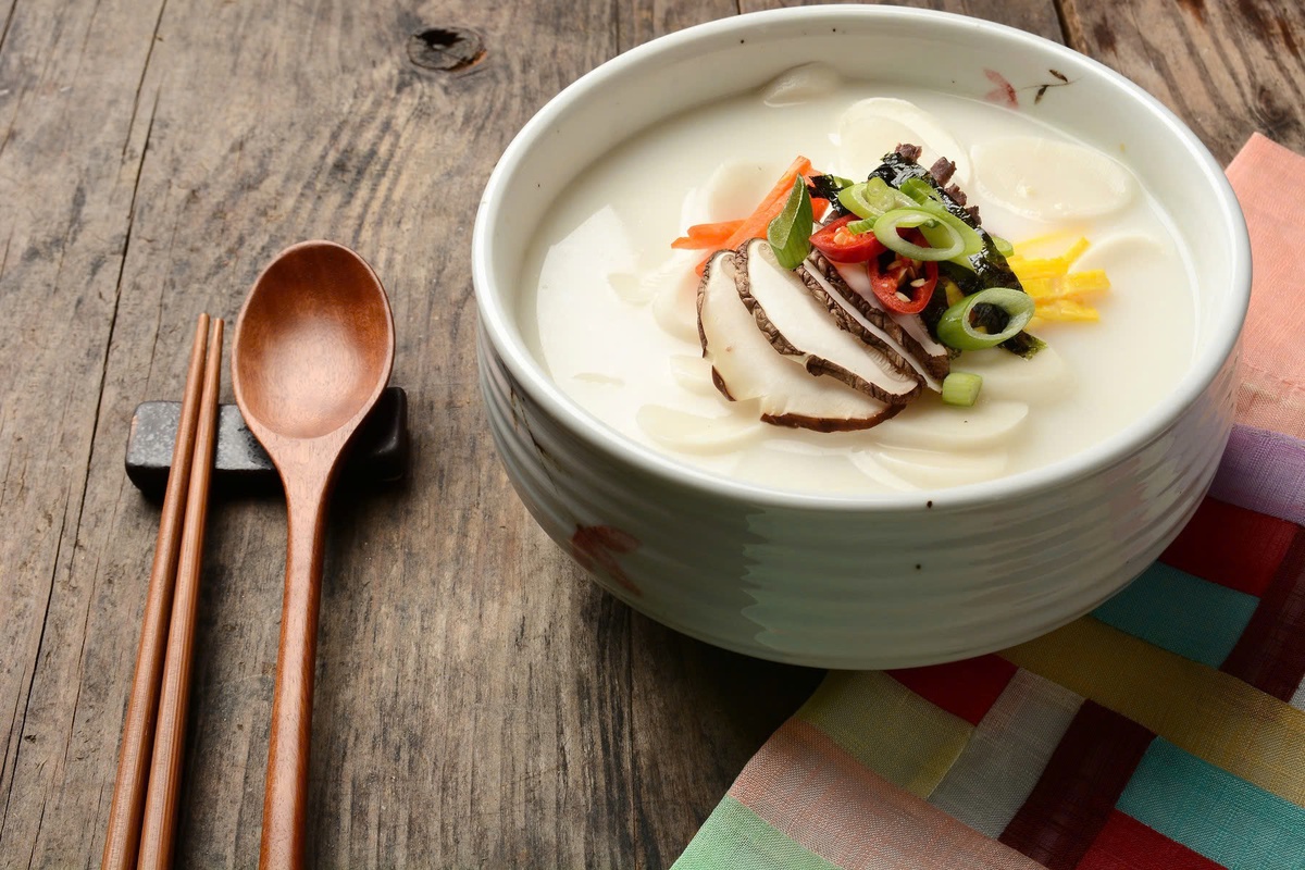 Những lát bánh gạo trắng tròn, mỏng tượng trưng cho đồng xu, gửi gắm mong ước về tài lộc và thịnh vượng. Tùy vùng miền và gia đình, canh bánh gạo có thể được thêm trứng thái sợi, hành lá hoặc rong biển