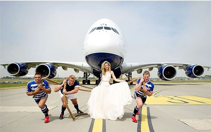 Người mẫu Georgia May Jagger bên cạnh 3 cầu thủ bóng bầu dục kéo chiếc Airbus A380 ở sân bay Manston, Anh