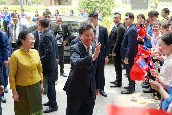 Ông Thongloun Sisoulith cùng  Phu nhân tươi cười chào các thanh niên Việt Nam và du học sinh Lào đứng đón mừng