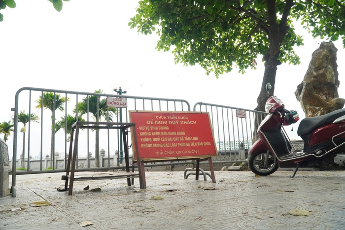 Đình chùa ở Hà Nội đóng cửa trong ngày đầu giãn cách xã hội, người dân đứng ở ngoài khấn vái  - Ảnh 13.