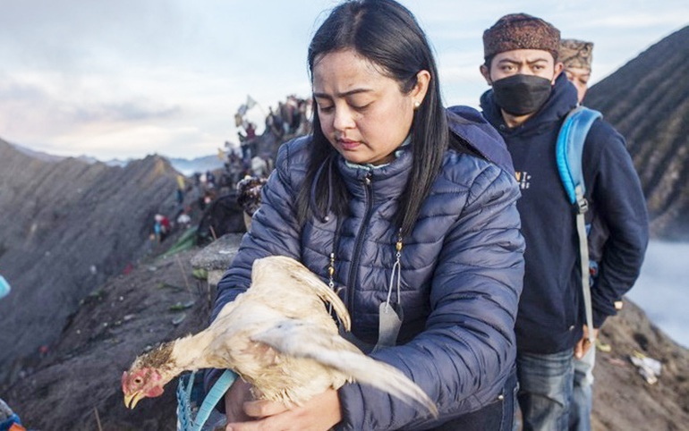 Một thành viên bộ tộc Tengger chuẩn bị ném gà hiến tế vào miệng núi lửa Mount Bromo đang hoạt động ở tỉnh Đông Java. Ảnh: AFP