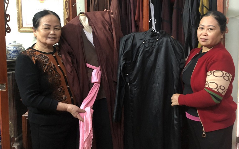 2 chị em nghệ nhân Nguyễn Thị Sang (trái) và Nguyễn Thị Thềm giới thiệu áo của người chơi quan họ