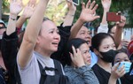 Mẹ đứng trước cổng dõi xem con mặc áo lính trong ngày nhập ngũ
