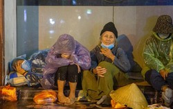 Hà Nội đón rét đậm rét hại, người vô gia cư co ro trong đêm với tấm áo mưa mỏng manh
