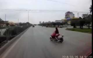 Mẹ suýt "giết" con vì vừa chạy xe máy vừa cởi áo mưa